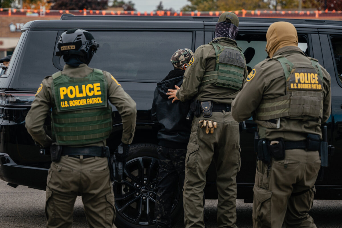Federal immigration agents arrest a man in the parking lot of an H-Mart grocery store, in Niles, Ill., on Oct. 31, 2025. (Jamie Kelter Davis/Getty Images)