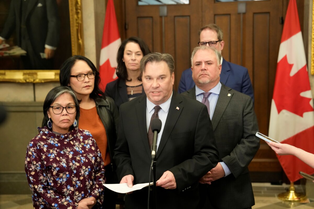 Interim NDP Leader Don Davies, surrounded by NDP MPs, speaks at a press conference following a vote on the federal budget on Parliament Hill in Ottawa on Nov. 17, 2025. (The Canadian Press/Adrian Wyld)