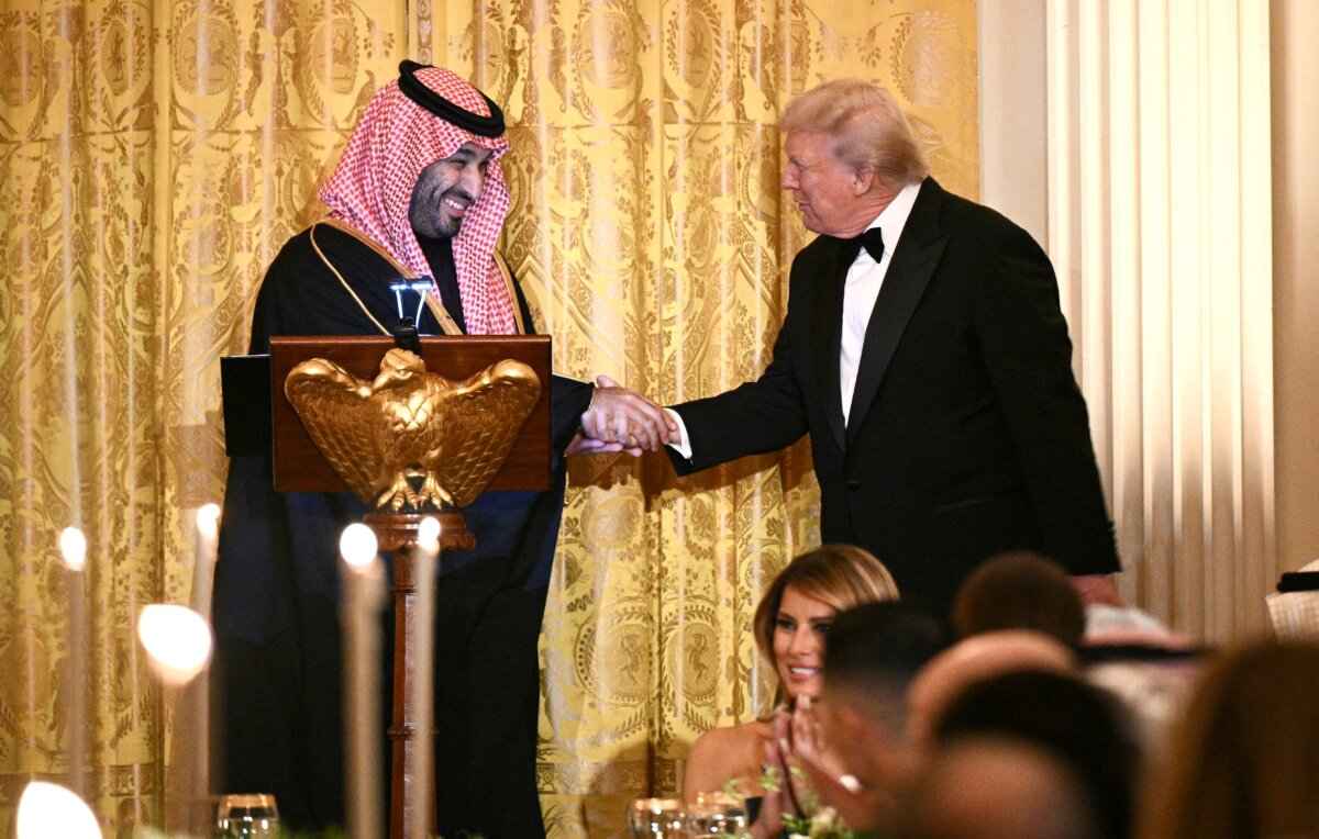 U.S. President Donald Trump shakes hands with Saudi Arabian Crown Prince and Prime Minister Mohammed bin Salman during an official dinner in the East Room of the White House on Nov. 18, 2025. (Brendan Smialowski/AFP via Getty Images)