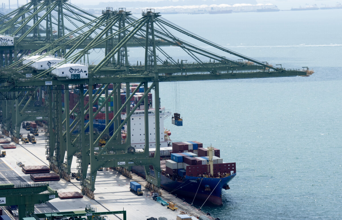 Ships are loaded and unloaded while docked in the port in Singapore on Oct. 28, 2025. (The Canadian Press/Adrian Wyld)
