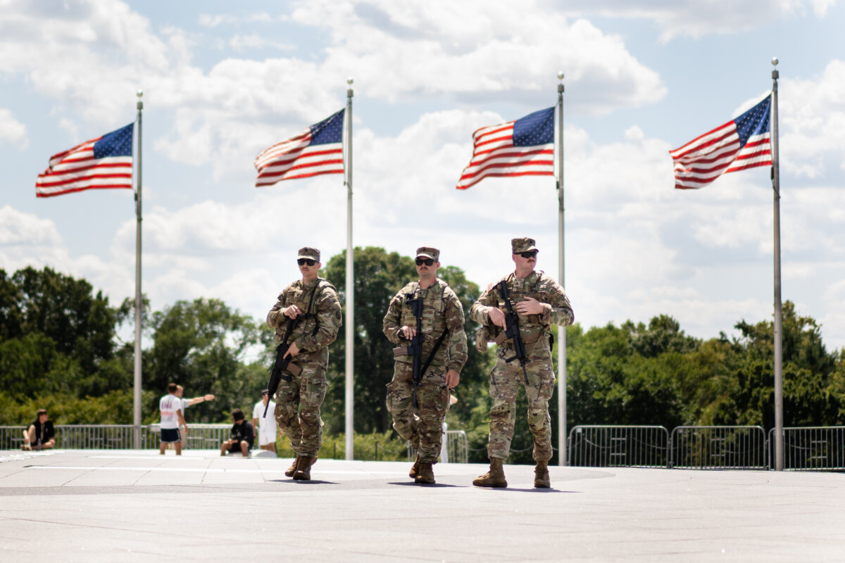 Armed National Guard members patrol the National Mall in Washington on Aug. 27, 2025. (Madalina Kilroy/The Epoch Times)
