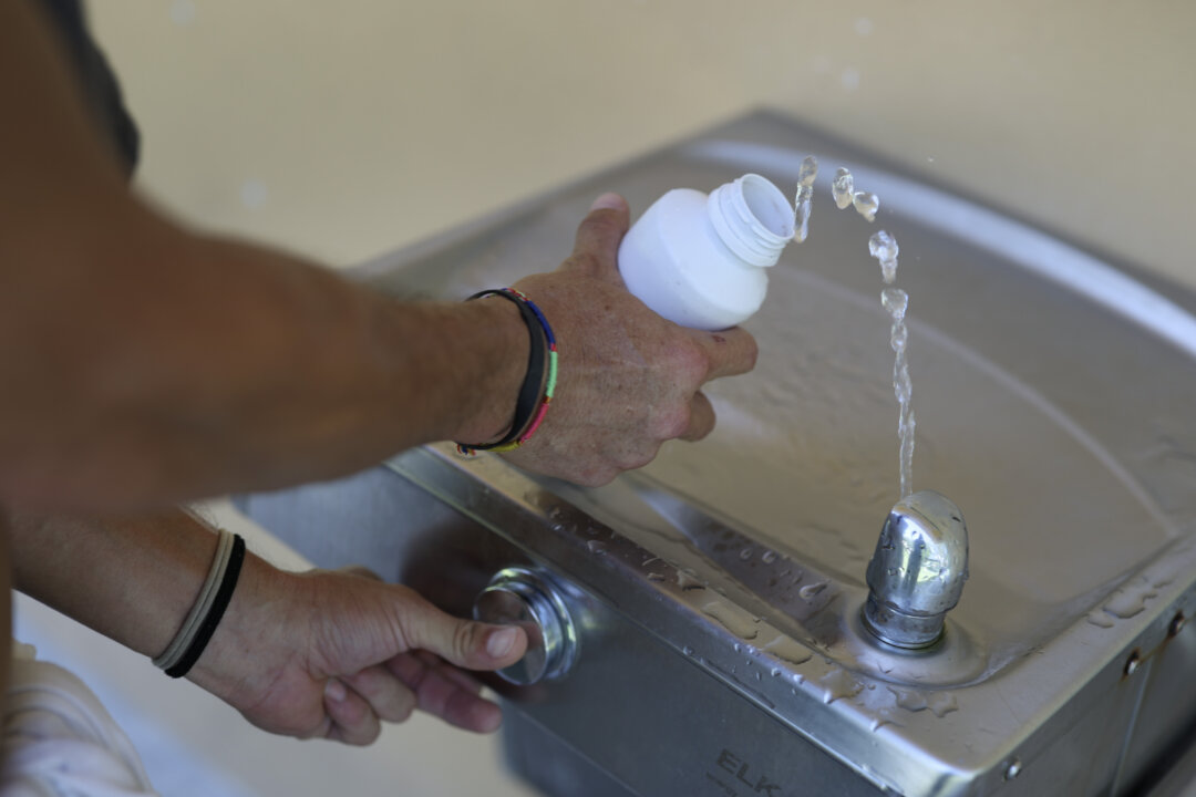 A person fills a bottle with water, in an undated file photograph. (Joe Raedle/Getty Images)