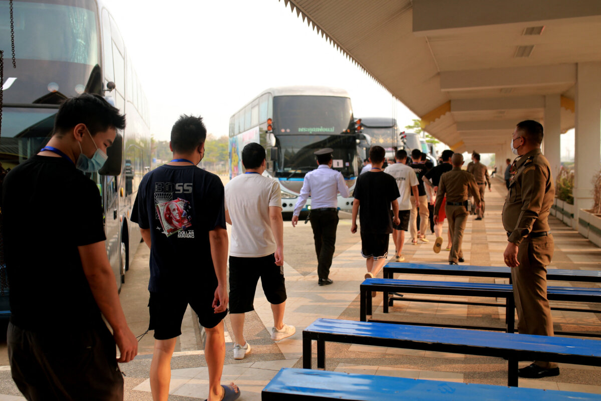 Alleged scam center workers and victims from China arrive at the border checkpoint with Thailand in Myawaddy township, Burma, on Feb. 20, 2025. (STR/AFP via Getty Images)