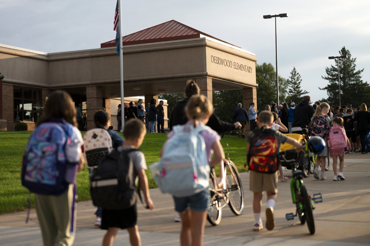 Parents drop off their children for the first day of school at Deerwood Elementary in Eagan, Minn., on Sept. 2, 2025. (Stephen Maturen/Getty Images)