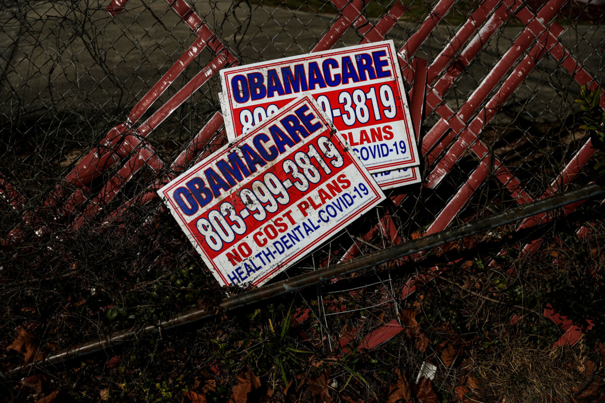 Signs for Obamacare health insurance plans next to a fence in Columbia, S.C., on Jan. 28, 2023. (Shannon Stapleton/Reuters)