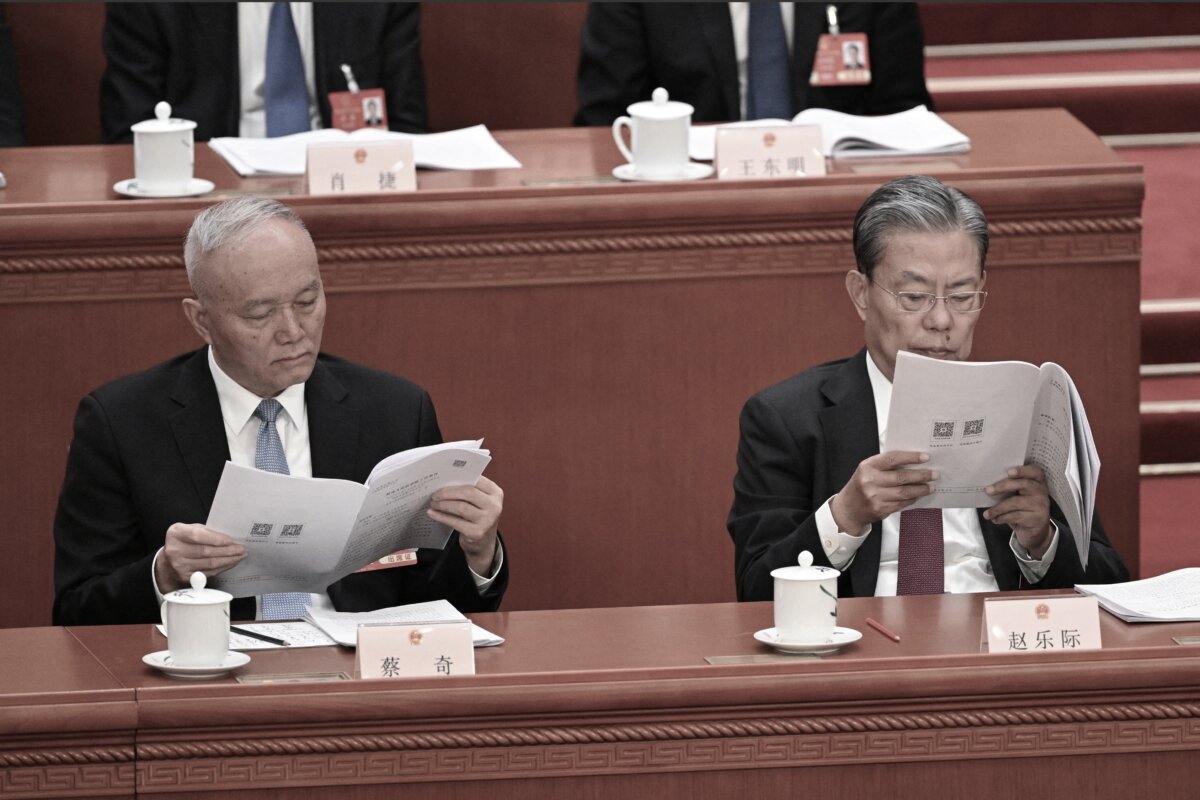 Politburo Standing Committee member Cai Qi (L) and Zhao Leji, Chairman of the Standing Committee of the National People's Congress, read speeches during the second plenary session of the National People's Congress in Beijing’s Great Hall of the People on March 8, 2025. (Greg Baker/ AFP via Getty Images)