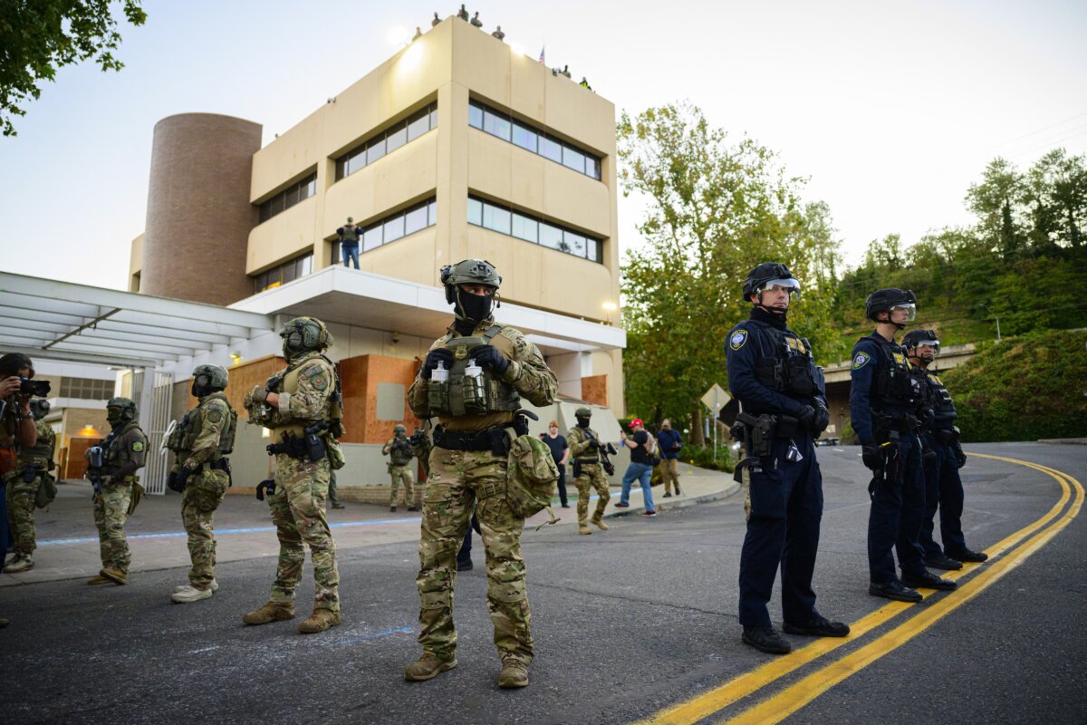 Federal agents stand guard outside an Immigration and Customs Enforcement facility in Portland, Ore., on Oct. 6, 2025. (Mathieu Lewis-Rolland/AFP via Getty Images)