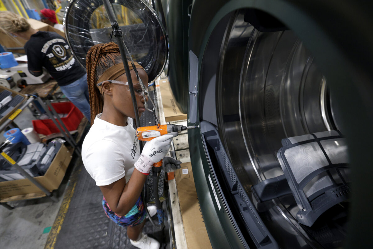 A plant employee works on the laundry production line at GE Appliances, in Louisville, Ky., on Aug. 8, 2025. (Michael Hickey/Getty Images for GE Appliances)