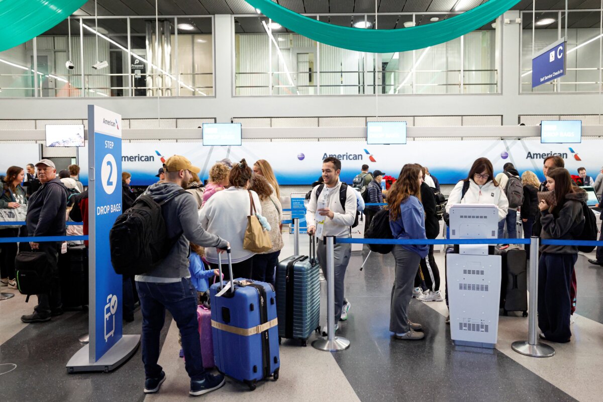 Travelers check in at O'Hare International Airport in Chicago on Nov. 25, 2025. (Kamil Krzaczynski/AFP via Getty Images)