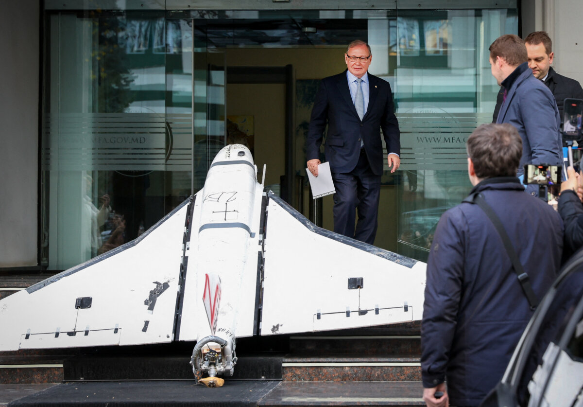 Oleg Ozerov (C), Russian ambassador to Chisinau, looks at a Russian-made Gerbera drone recovered by the Moldovan police on Nov. 25, 2025, and exposed on the stairs at the entrance of the Ministry of Foreign Affairs of Moldova in Chisinau on Nov. 26, 2025. (Elena Covalenco/AFP via Getty Images)