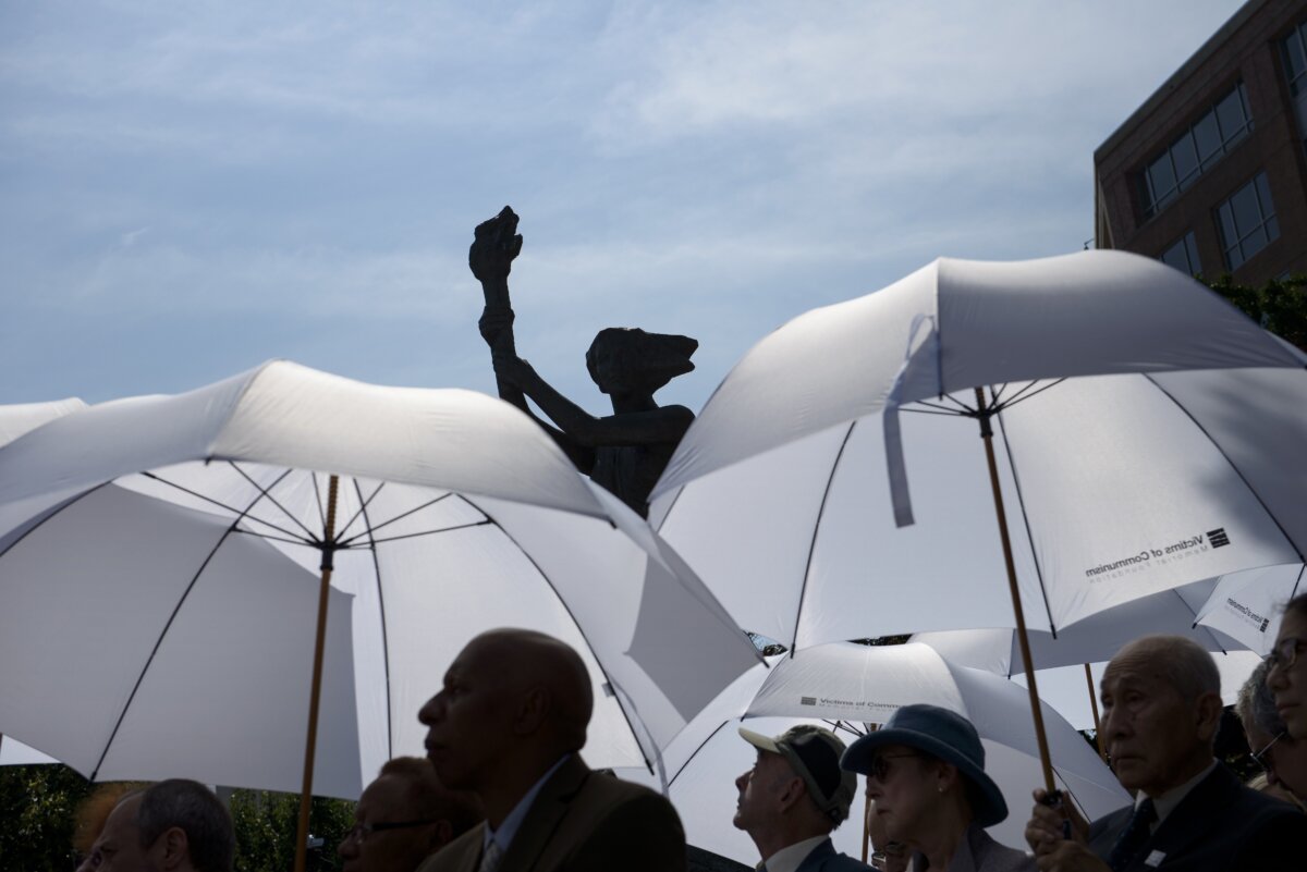 People listen during an event by the Victims of Communism Memorial monument in Washington on June 12, 2015. (Brendan Smialowski/AFP via Getty Images)
