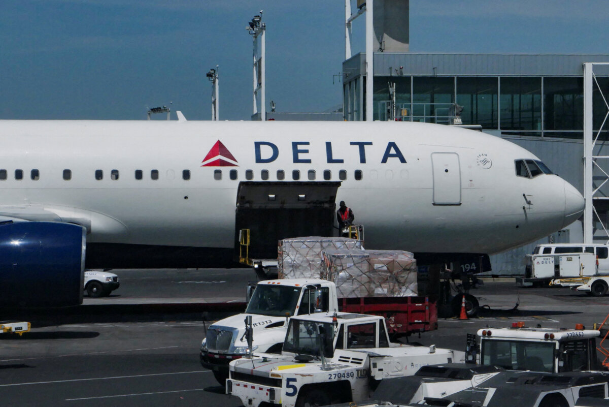 A staff uploads packages on a Delta Air Lines plane at John F. Kennedy International Airport in Queens, New York City, on April 23, 2025. (Jeenah Moon/Reuters)