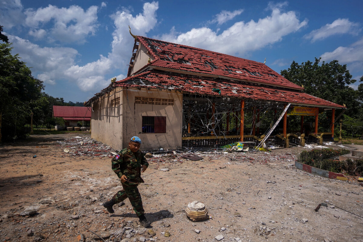 A Cambodian soldier walks past a damaged building during a visit of delegation of foreign diplomats to inspect the area along the Thailand-Cambodia's border, following a cease-fire between Cambodia and Thailand, in Oddar Meanchey, Cambodia, on Aug. 1, 2025. (Soveit Yarn/Reuters File Photo)