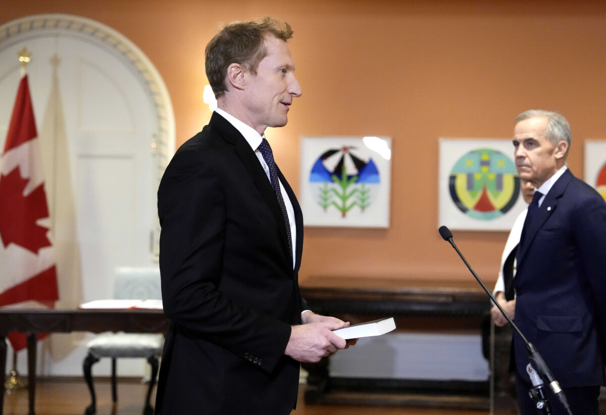 Mark Miller is sworn in as Minister of Canadian Identity and Culture and Minister responsible for Official Languages as Prime Minister Mark Carney looks on, at a cabinet swearing in ceremony at Rideau Hall in Ottawa, on Dec. 1, 2025. (The Canadian Press/Justin Tang)
