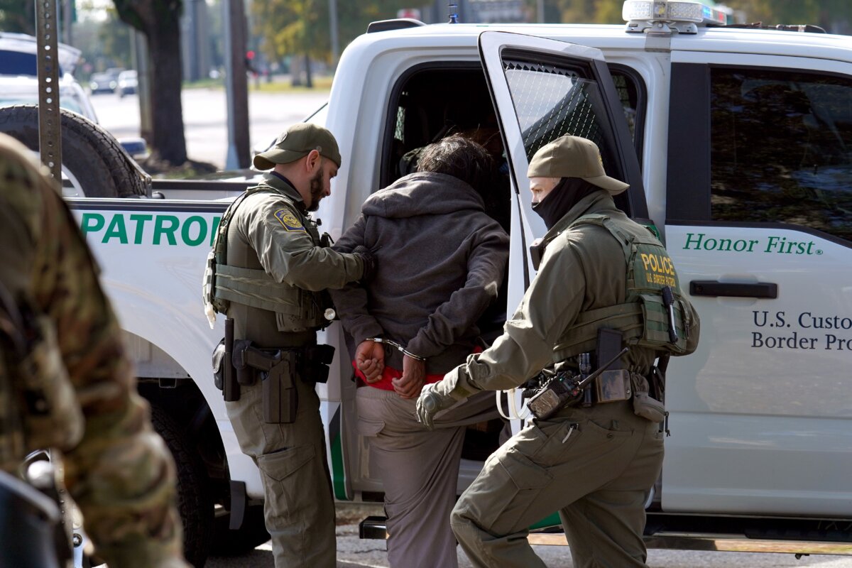 Border Patrol agents detain a man on the street in New Orleans on Dec. 3, 2025. (Ryan Murphy/Getty Images)