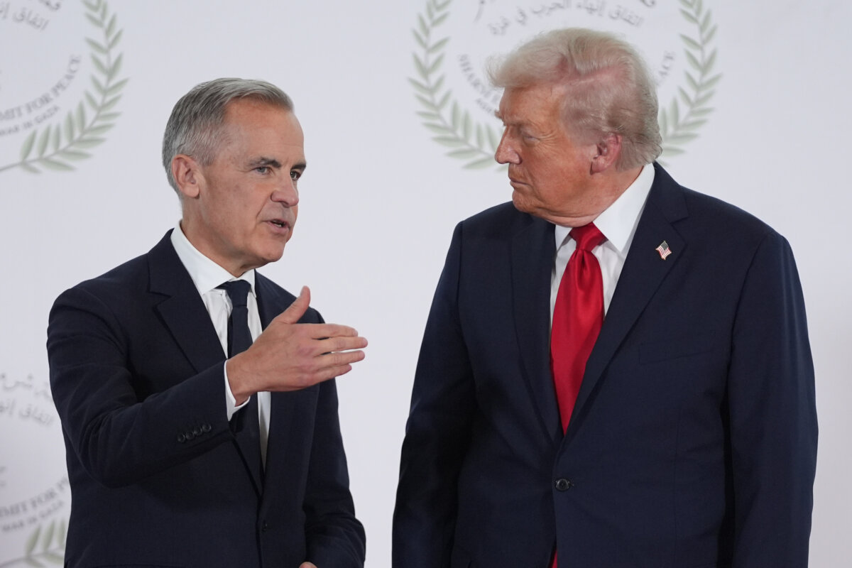 U.S. President Donald Trump greets Canadian Prime Minister Mark Carney during a summit on ending the Israel-Hamas war in Sharm El Sheikh, Egypt, on Oct. 13, 2025. (AP Photo/Evan Vucci, Pool)
