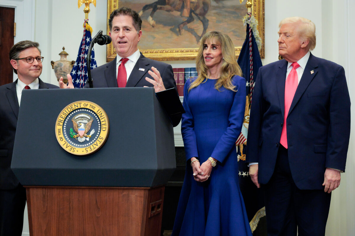 Michael Dell speaks as House Speaker Mike Johnson (R-La.) and President Donald Trump look on during a “Trump accounts” announcement at the White House in Washington on Dec. 2, 2025. (Chip Somodevilla/Getty Images)