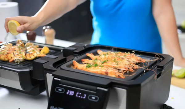 Gourmax Pro, the ultimate 11-in-1 multi-cooker, transforms into an indoor smokeless grill, air fryer, griddle, slow cooker, oven, steamer, dehydrator, panini press, toaster, pancake maker, and reheating station.