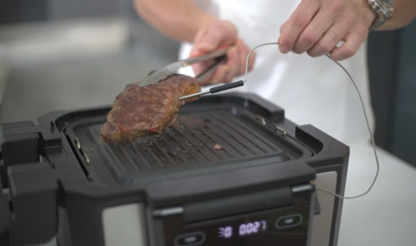 Gourmax Pro, the ultimate 11-in-1 multi-cooker, transforms into an indoor smokeless grill, air fryer, griddle, slow cooker, oven, steamer, dehydrator, panini press, toaster, pancake maker, and reheating station.