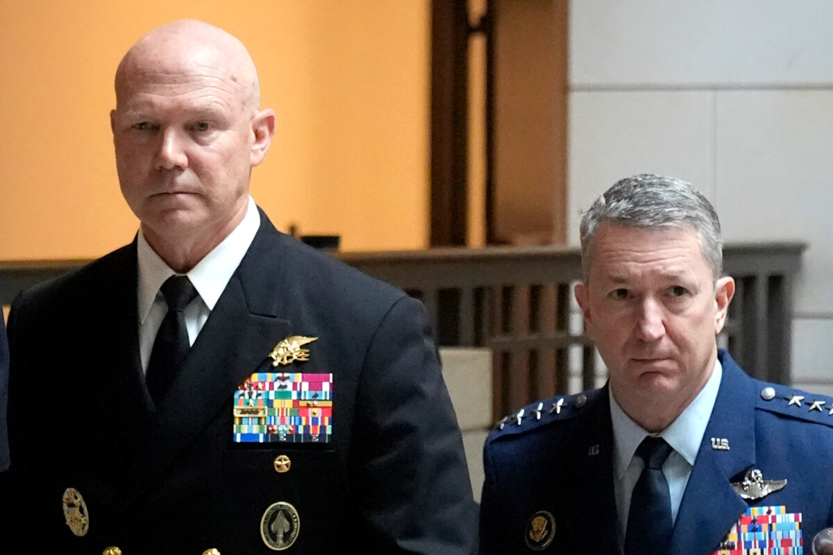 U.S. Navy Adm. Frank M. Bradley, accompanied by Gen. Dan Caine, chairman of the Joint Chiefs of Staff (R), walks to a meeting with senators on Capitol Hill in Washington on Dec. 4, 2025. (Mark Schiefelbein/AP Photo)