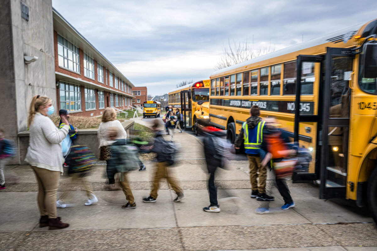 Students exit the school bus at Carter Traditional Elementary School in Louisville, Ky., on Jan. 24, 2022. (Jon Cherry/Getty Images)