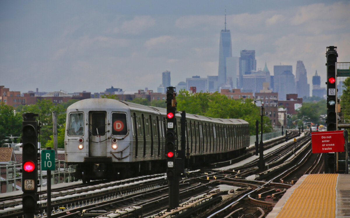 A subway approaches an above ground station in the Brooklyn borough of New York with the New York City skyline in the background, on June 21, 2017. (Bebeto Matthews/AP Photo)