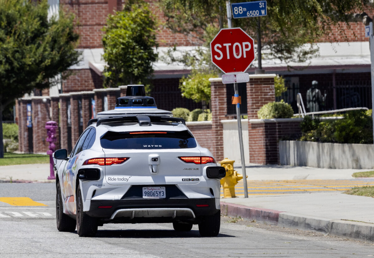 A self-driving Waymo vehicle awaits passengers in Los Angeles on July 1, 2025. (John Fredricks/The Epoch Times)