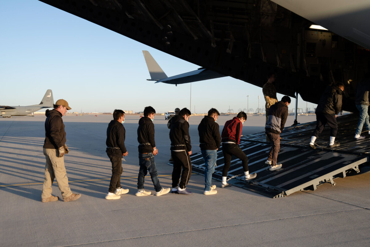 U.S. Customs and Border Protection security agents guide illegal immigrants onboard a C-17 Globemaster III assigned to the 60th Air Mobility Wing for a removal flight at Fort Bliss, Texas, on Jan. 23, 2025. (Dept. of Defense photo by U.S. Army Sgt. 1st Class Nicholas J. De La Pena)