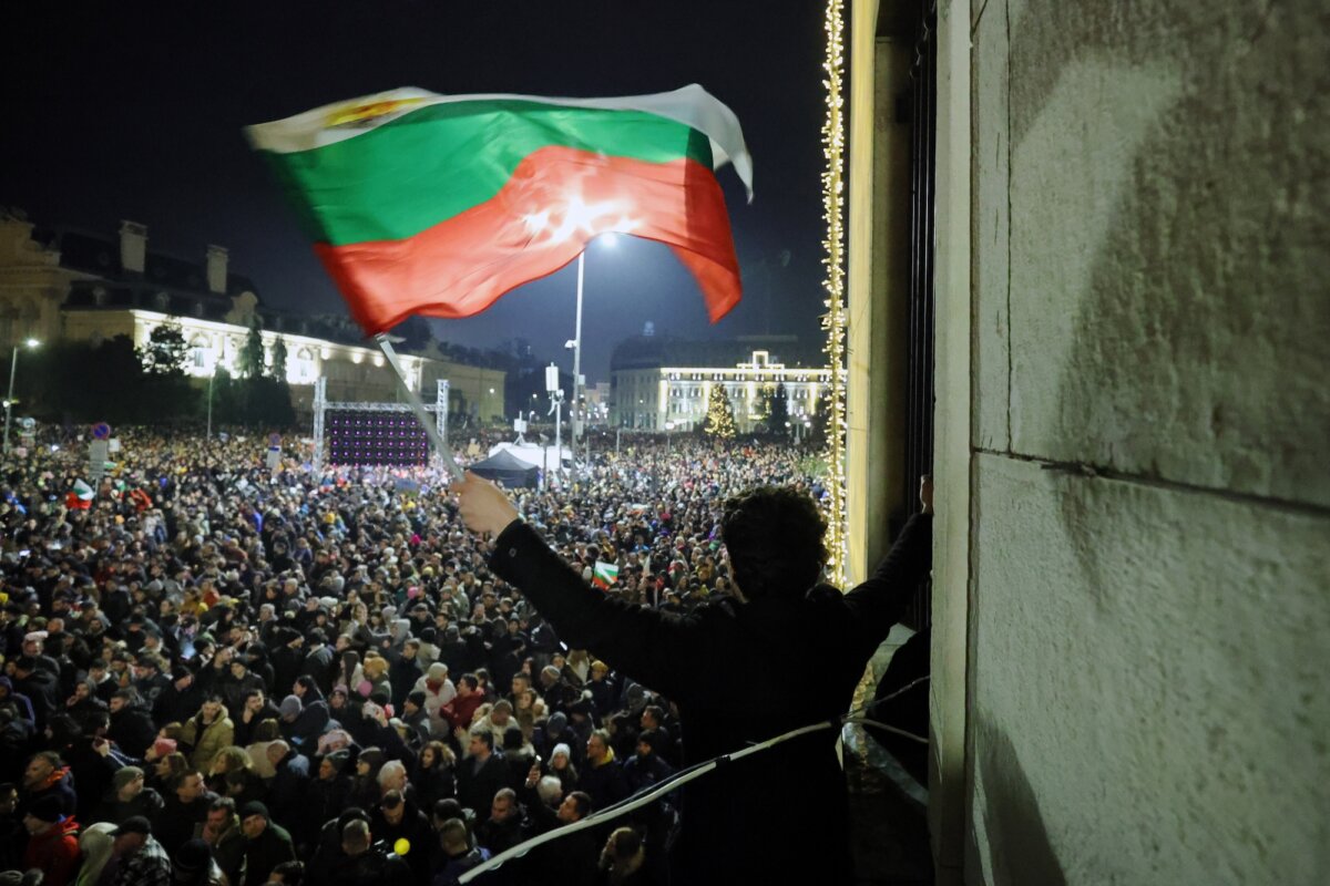 A student waves a Bulgarian flag as tens of thousands of Bulgarians protest, demanding the government's resignation, in Sofia, Bulgaria, on Dec. 10, 2025. (AP Photo/Valentina Petrova)