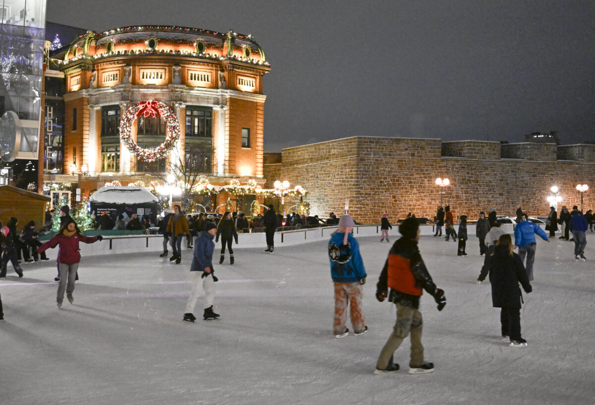 People skate at the Place-Youville rink, decorated for Christmas, in Quebec City on Dec. 6, 2025. (The Canadian Press/Jacques Boissinot)