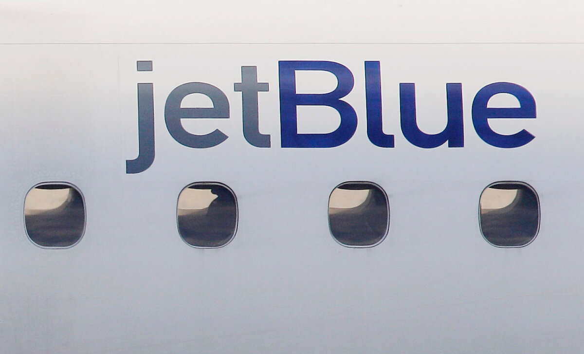 A JetBlue logo is displayed on the side of a jet as it taxis at Boston's Logan International Airport on Jan. 20, 2011. (Stephan Savoia/AP Photo)