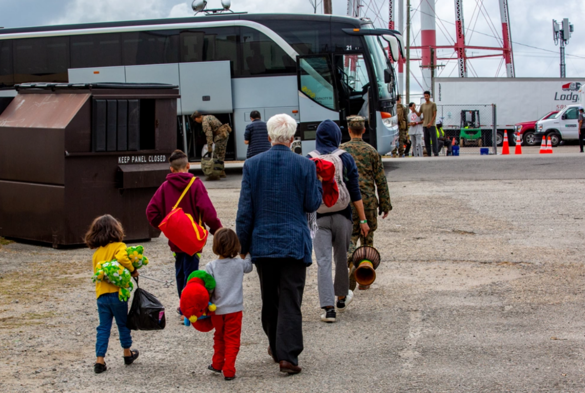 Evacuees from Afghanistan are transported to a temporary lodging after arriving at Fort Pickett, Va., Oct. 6, 2021. (Cpl. Eric Ramirez/U.S. Marine Corps)