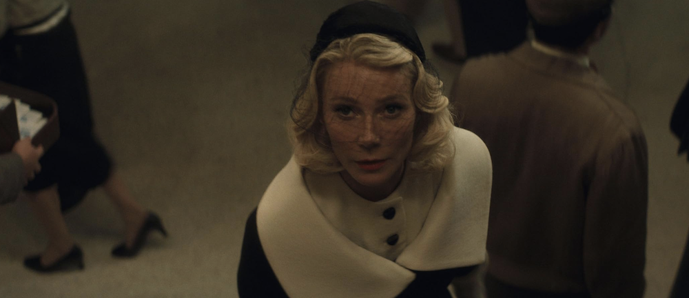 blond women with veil looks upwards in Marty Supreme