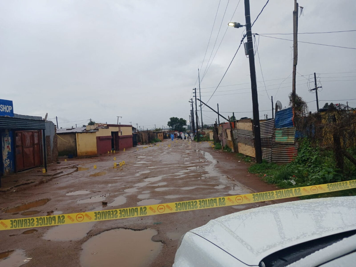 Photo marker cones are placed across the scene after an early morning shooting in Bekkersdal township south-west of Johannesburg, South Africa, on Dec. 21, 2025. (South African Police Services/Handout via Reuters)
