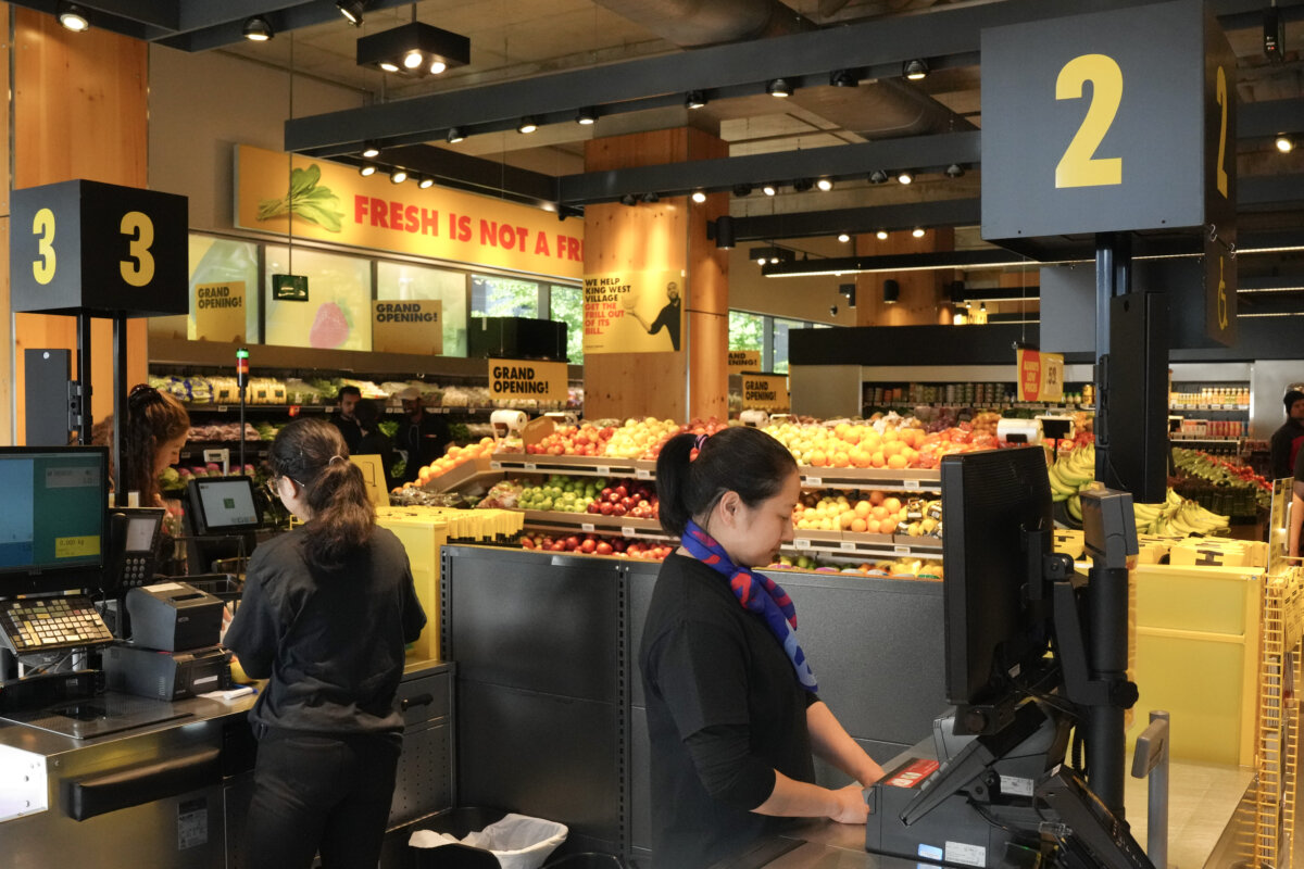 An attendant stands at the checkout at a No Frills Grocery store in Toronto, on May 30, 2024. (The Canadian Press/Chris Young)