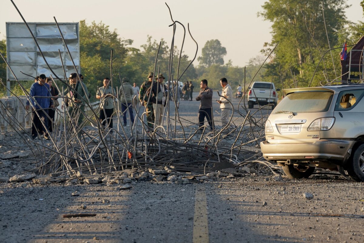 People look at a bridge damaged in air strikes in Cambodia, on Dec. 20, 2025. (AFP via Getty Images)