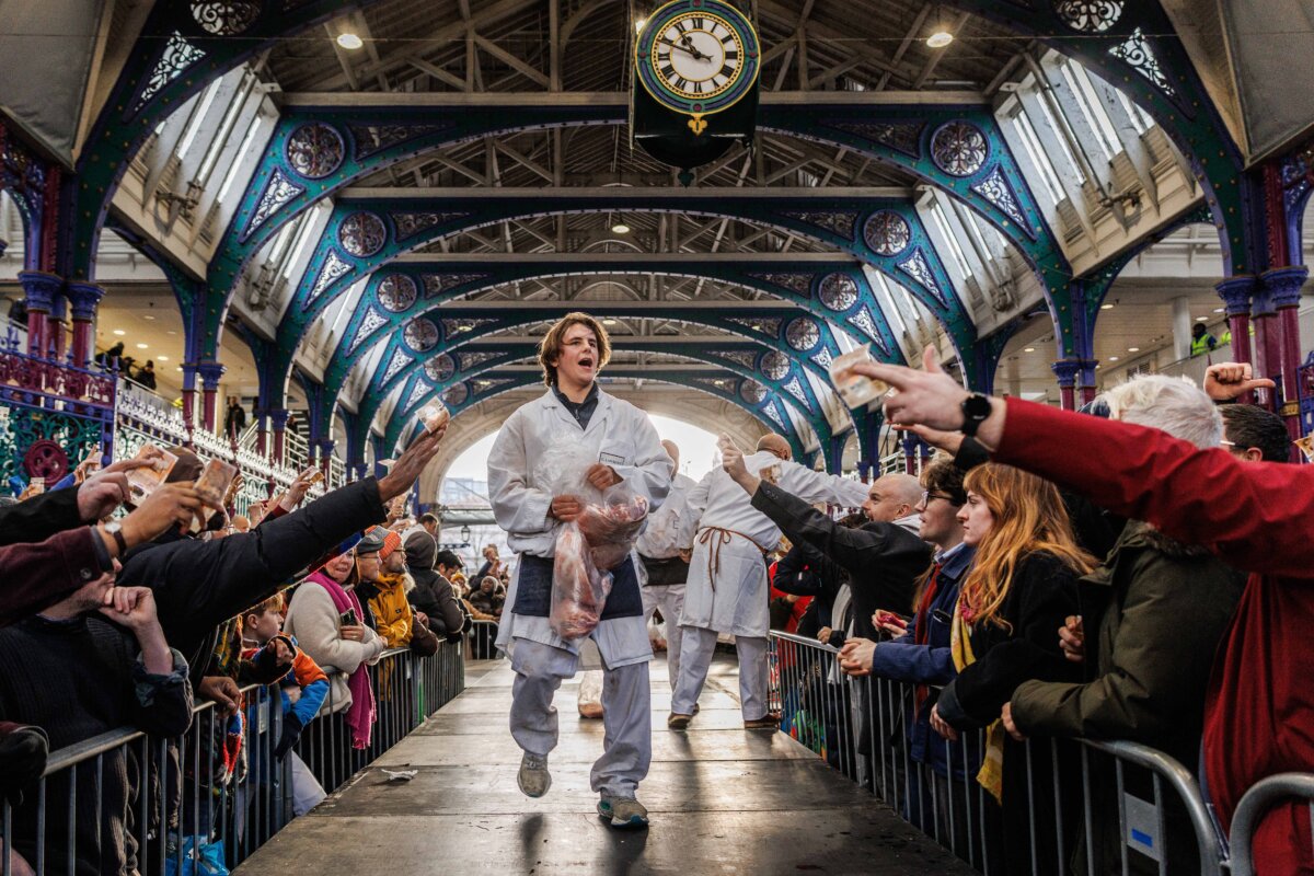 Workers sell joints of meat during the annual Christmas Eve meat auction at Smithfield Market in London on Dec. 24, 2025. For the past century, the historic market traditionally held a meat sale on Christmas Eve where traders sell off surplus meats. In 2024, it was announced that Smithfield, the largest wholesale meat market in the UK, would permanently close by 2028. The closure will bring an end to more than 800 years of trading at the location. (Dan Kitwood/Getty Images)