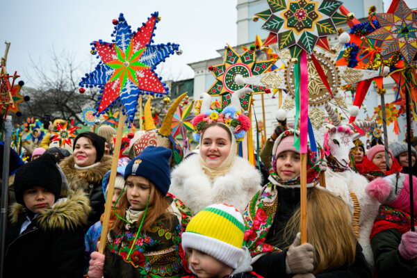 Day in Photos: Christmas Procession, Guinea's Presidential Election, and Camel Race