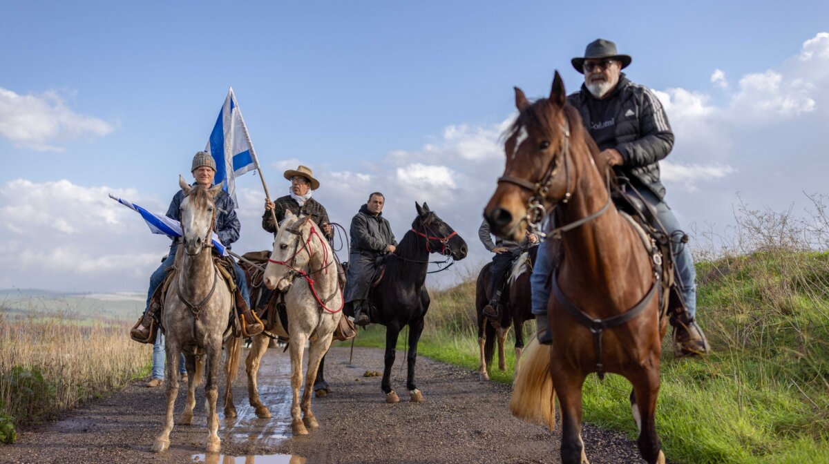 Horsemen with Israeli flags honor teenager Aviv Maor, who was killed in a stabbing-ramming terror attack three days earlier, at a cemetery in the Israeli Kibbutz of Ein Harod, on Dec. 29, 2025. (Ilia Yefimovich/AFP via Getty Images)