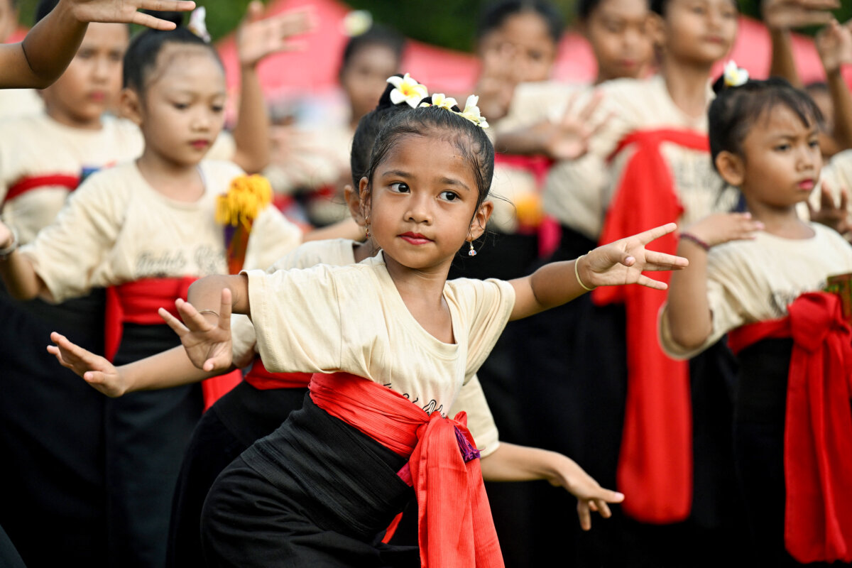 Children perform a traditional Balinese dance to release the sun of 2025, and to welcome the sun of 2026, during a New Year's Eve celebration in Denpasar, on Indonesia's resort island of Bali, on Dec. 31, 2025. (Sonny Tumbelaka/AFP via Getty Images)