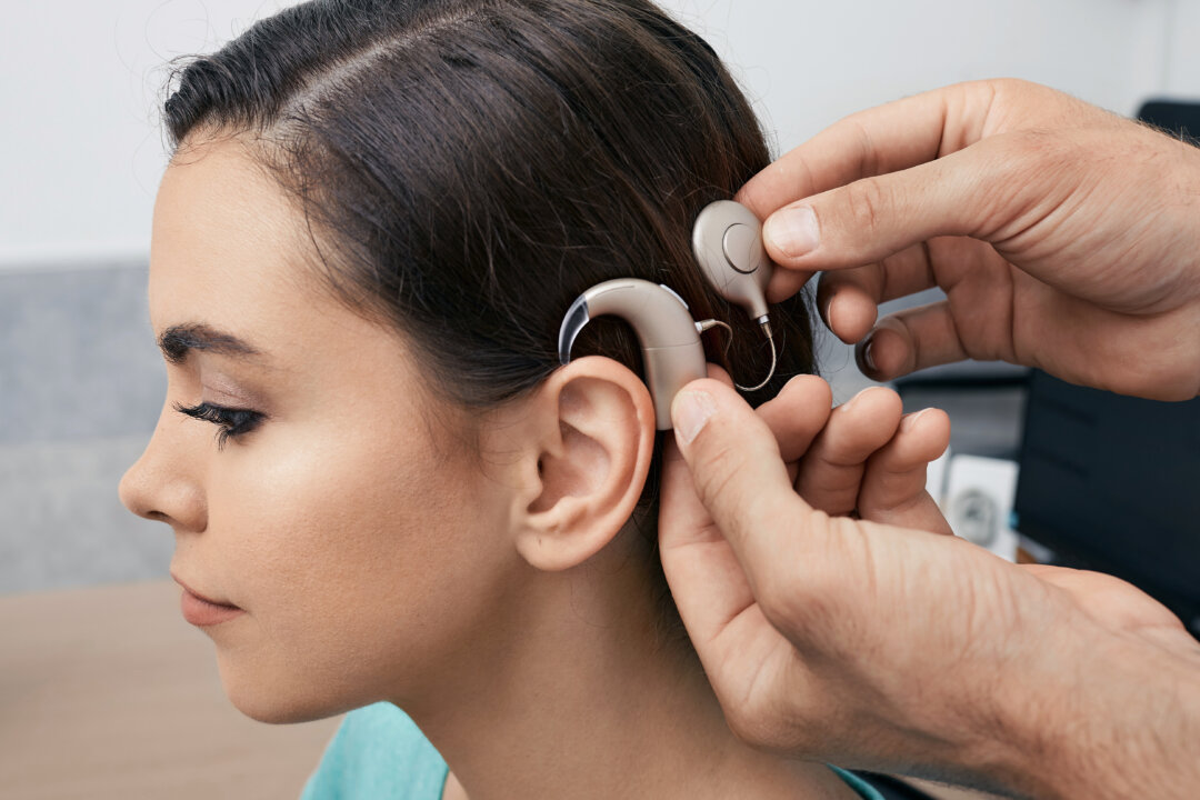 Unlike hearing aids, which amplify sound, a cochlear implant helps the brain process sound. (Peakstock/Shutterstock)