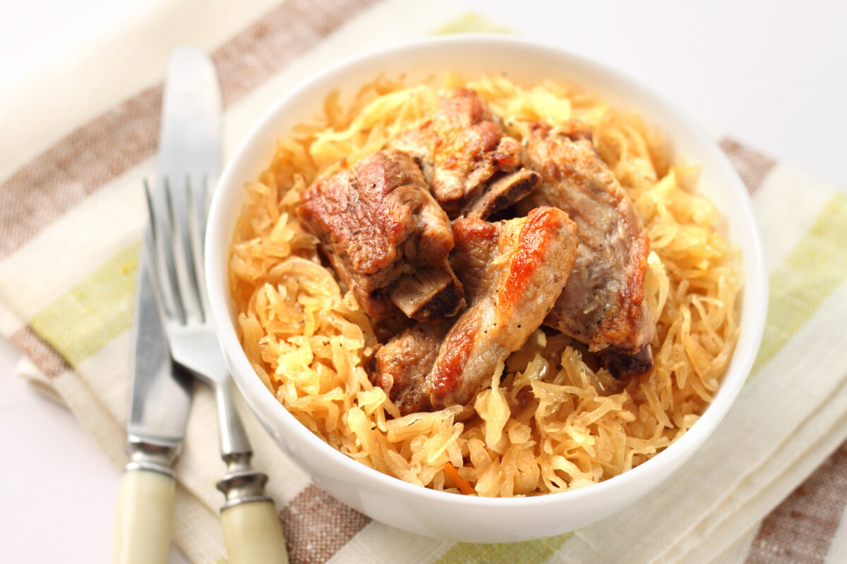 Pork ribs baked with sauerkraut. (TYNZA/Shutterstock)