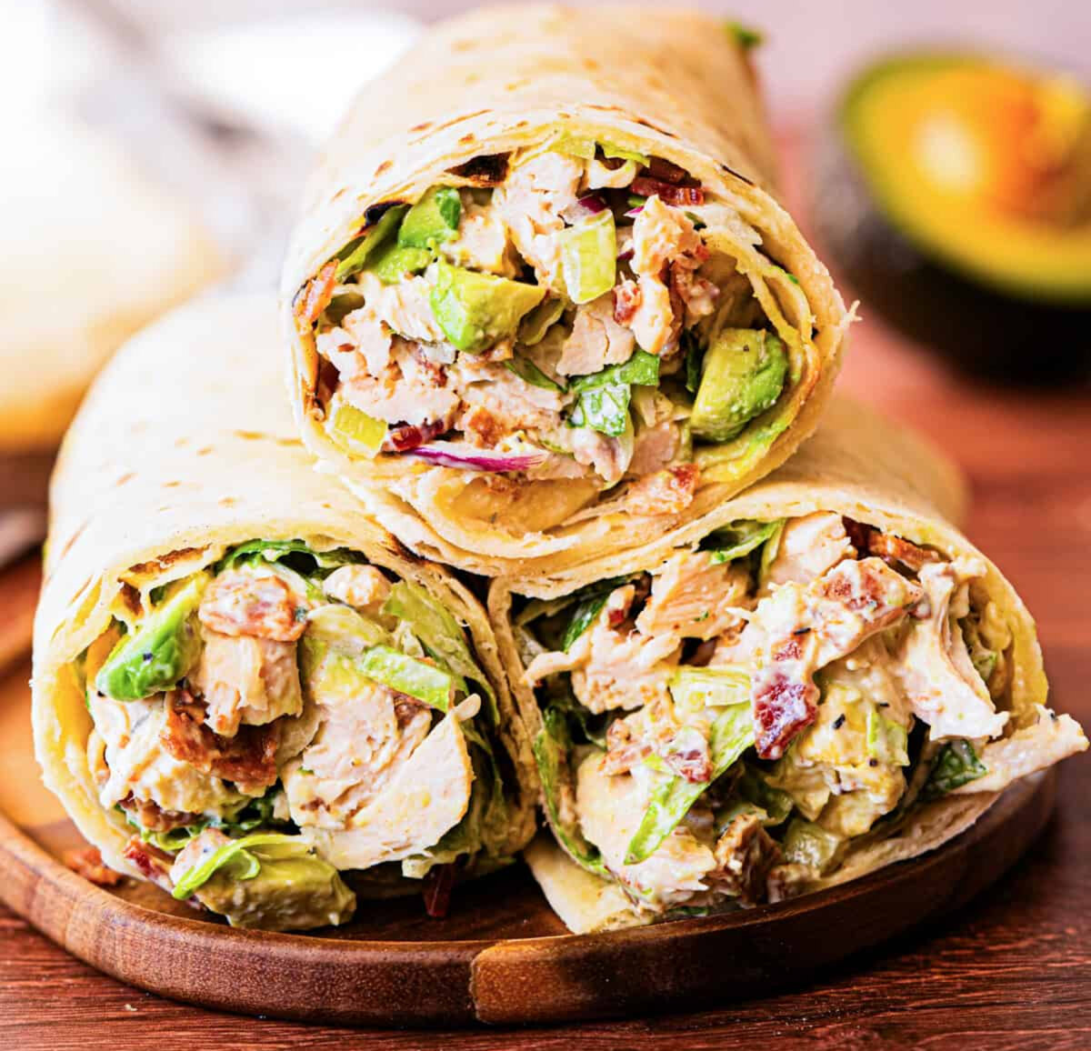 This Chicken Bacon Avocado Wrap is ready in 15 minutes, loaded with tender chicken, crispy bacon, fresh avocado, and romaine lettuce in a creamy lemon-basil dressing. (Lauren Allen)