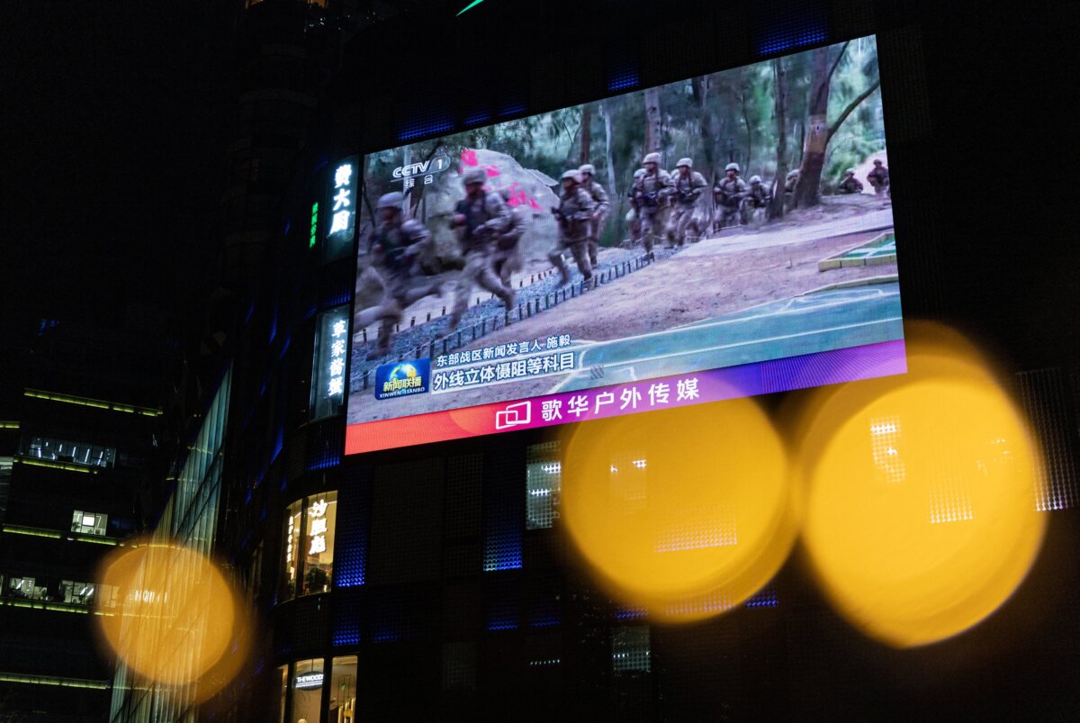 A giant city screen broadcasts news on China's military drills around Taiwan through New Year decorations, in Beijing, on Dec. 29, 2025. (Maxim Shemetov/Reuters)