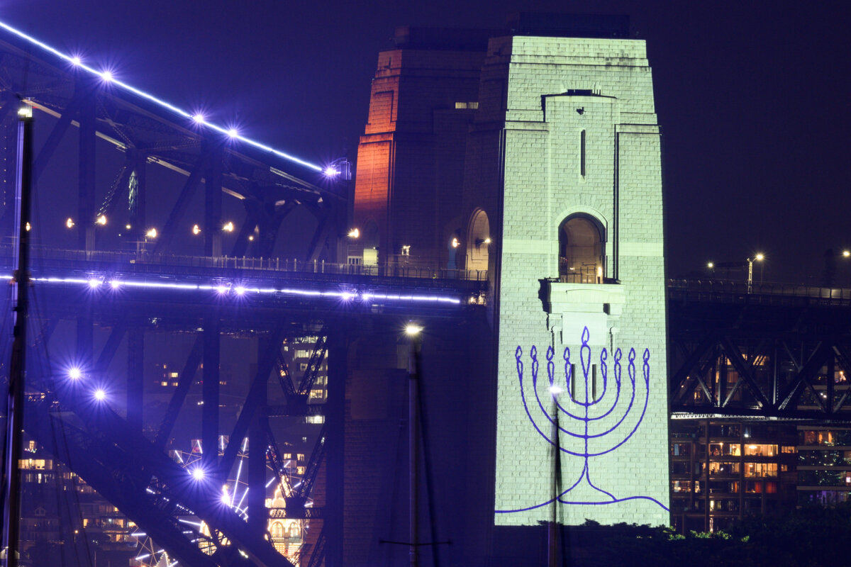 An image of a menorah is projected onto the pylons of the Sydney Harbour Bridge during New Year’s Eve celebrations on December 31, 2025, in Sydney, Australia. The projection was in tribute to the 15 victims of the Bondi Beach terror attack on December 14, 2025. (Photo by Izhar Khan/Getty Images)