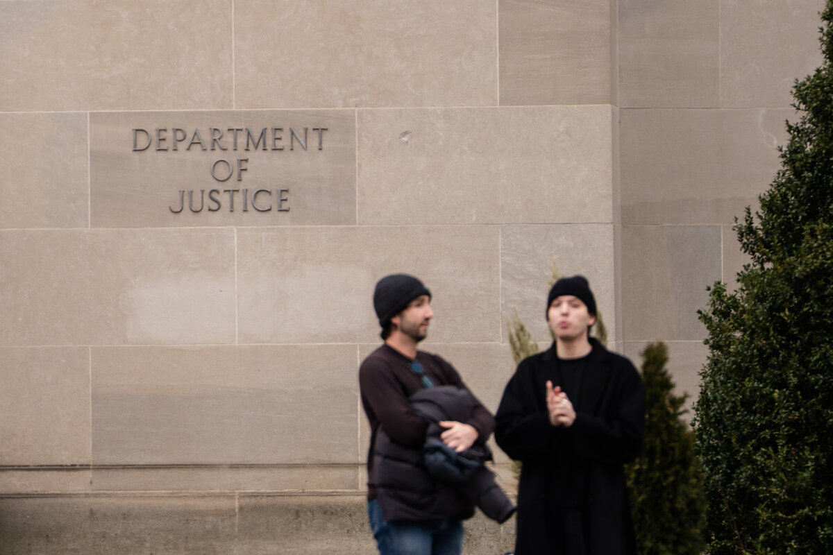 People stand outside the Department of Justice building in Washington on Jan. 6, 2026. (Madalina Kilroy/The Epoch Times)