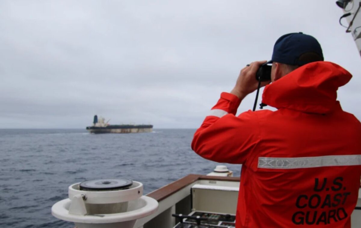 An undated photo uploaded by the U.S. European Command on Jan. 7, 2026, shows a U.S. Coast Guard official surveying a ship. (US European Command via The Epoch Times)