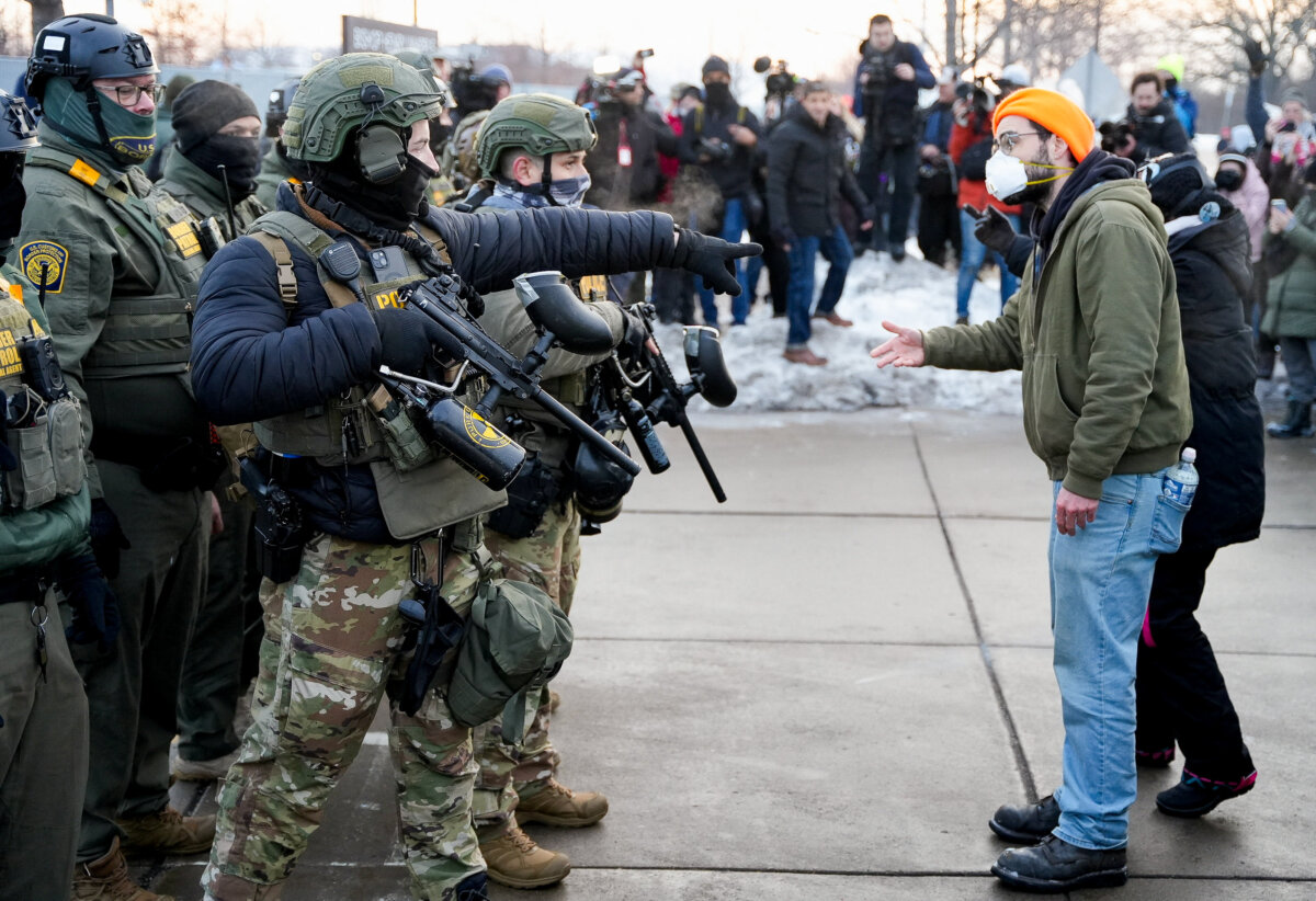 A federal agent gestures toward a demonstrator at a rally against increased immigration enforcement in Minneapolis on Jan. 8, 2026. (Tim Evans/Reuters)