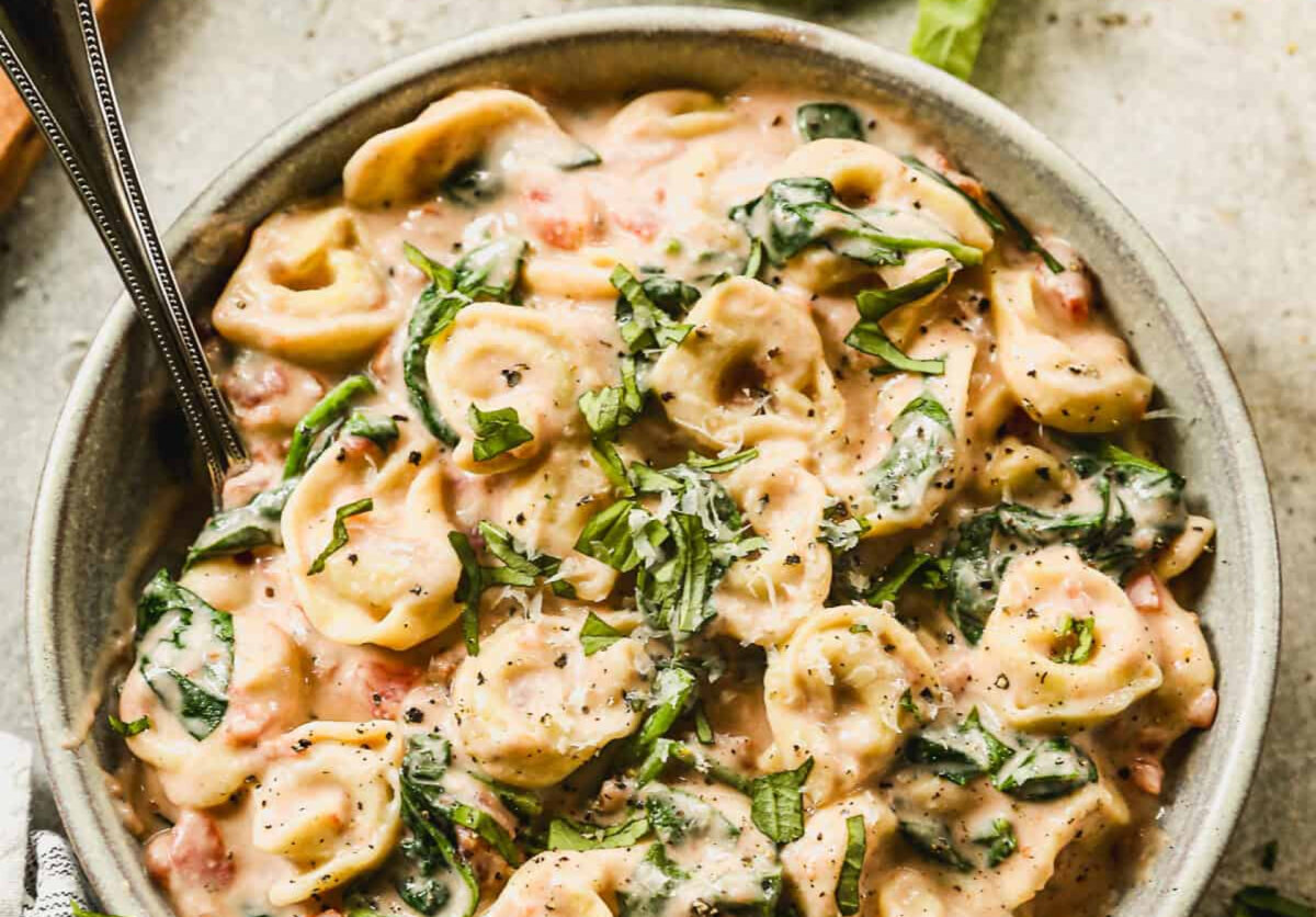 Our easy Creamy Tomato Tortellini with spinach is a one-pan pasta recipe that comes together in less than 30 minutes using cheese tortellini, fresh spinach, and a simple homemade pink sauce made with tomatoes, cream, and parmesan. (Lauren Allen)