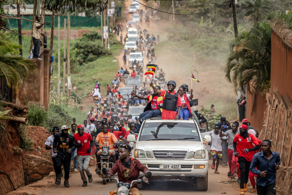 Opposition leader and presidential candidate for the National Unity Platform Robert Kyagulanyi Ssentamu, popularly known as Bobi Wine (C), waves a Ugandan flag atop a car as he is followed by a crowd of supporters on his way to a campaign rally in Kampala, Uganda, on Jan. 9, 2026, ahead of the 2026 Ugandan general elections. (Luis Tato/AFP via Getty Images)